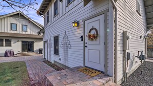A residential building with a white exterior, a front door with a wreath, a doormat, and a small porch area. - River Street Roost - 12 Miles to Sun Valley Resort (Hailey)