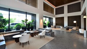 A spacious lobby with high ceilings, large windows, and modern seating areas. - EST Link to LRT KL Sentral Bangsar (Kuala Lumpur)