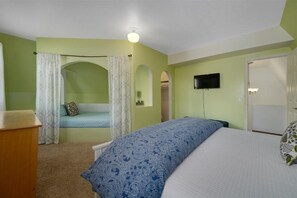Green bedroom with a curtained twin nook