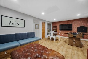 Game room with a long navy sectional