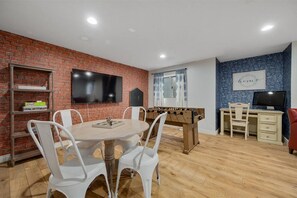 Game room with foosball, a TV, and a round table