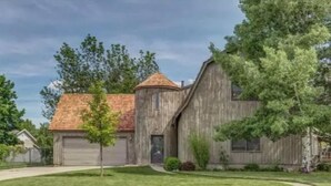 A single-story house with a garage, a small front yard, and a tree. - Unique Home Perfect for Gathering. Pets welcome! (Orem)