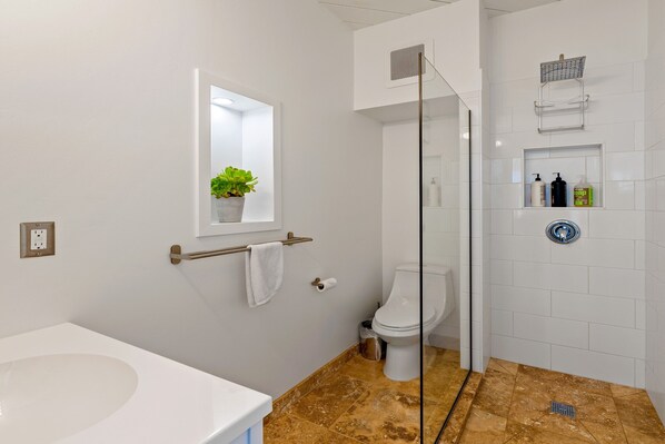 New spacious bathroom with rainwater head shower, lots of fluffy white towels