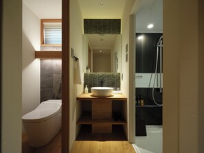 A modern bathroom with a toilet, a large sink, and a shower area. - lili kyoto (Kyoto)
