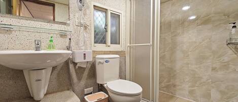 A bathroom with a sink, toilet, and shower.