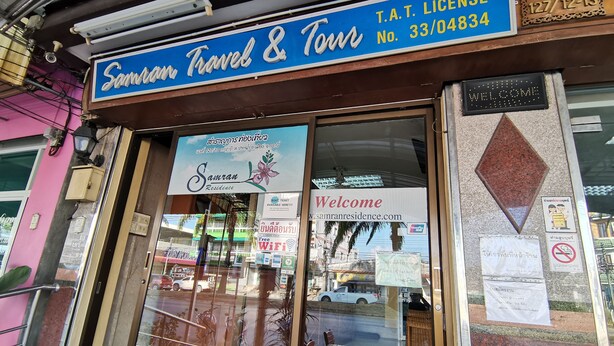 A storefront with a sign reading "Samran Travel & Tour" and a welcome sign. - Samran Residence (Krabi)