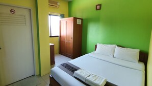 A hotel room with a bed, a wardrobe, a door, and a window. - Samran Residence (Krabi)