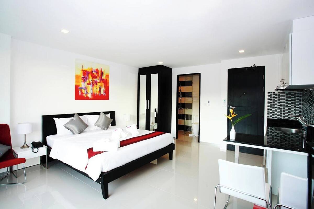 Une chambre d’hôtel moderne, dotée d’un grand lit, d’un bureau et d’une salle de bain.