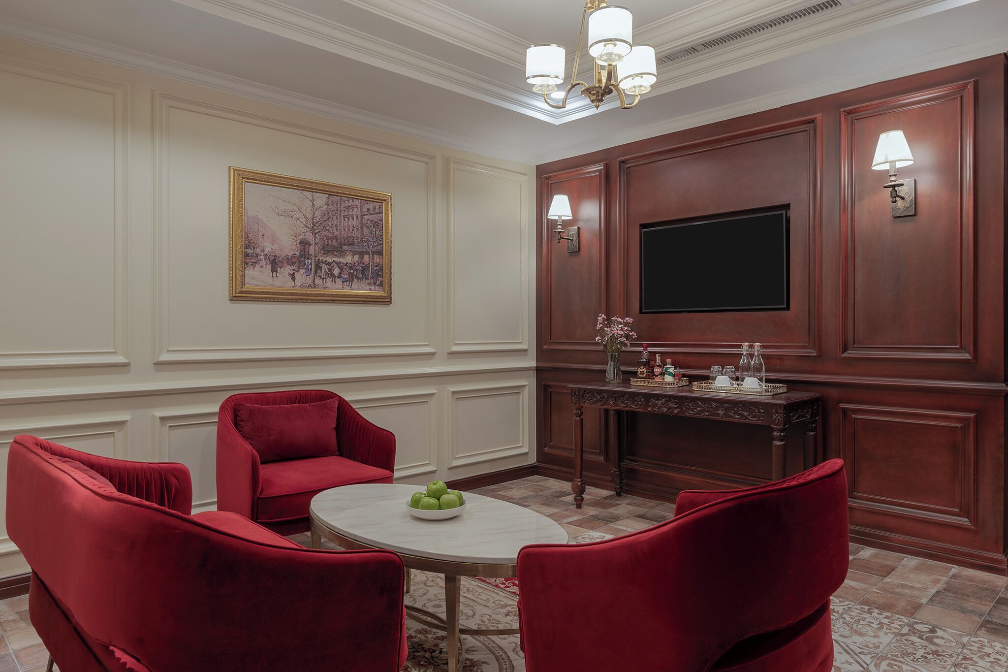 A conference room with a round table, red chairs, a large screen, and a fireplace.