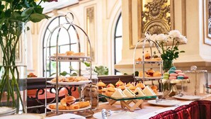 A buffet table with various food items and a decorative glass jar.