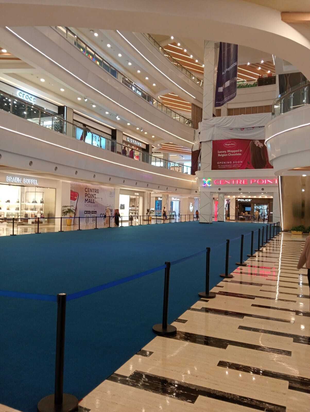 A multi-level shopping mall with various stores including a police department and a luxury chocolate shop.