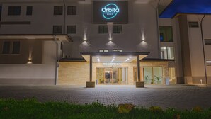 A modern hotel entrance with a reception area, illuminated signage, and a well-lit facade. - Spa Hotel Orbita (Blagoevgrad)