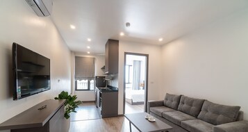 Superior King Apartment | Living room | Flat-screen TV