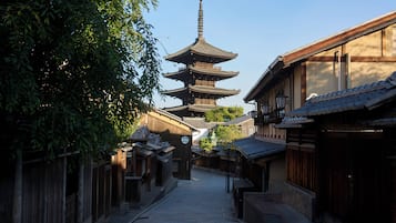 A traditional Japanese street with a multi-tiered pagoda in the background.