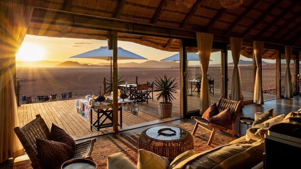 A spacious outdoor seating area with a view of the desert landscape. -  Kwessi Dunes (Sesriem)