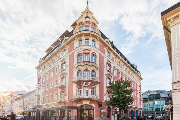 A historic building with a prominent 'Garner' sign, featuring classic architectural details and a corner location.