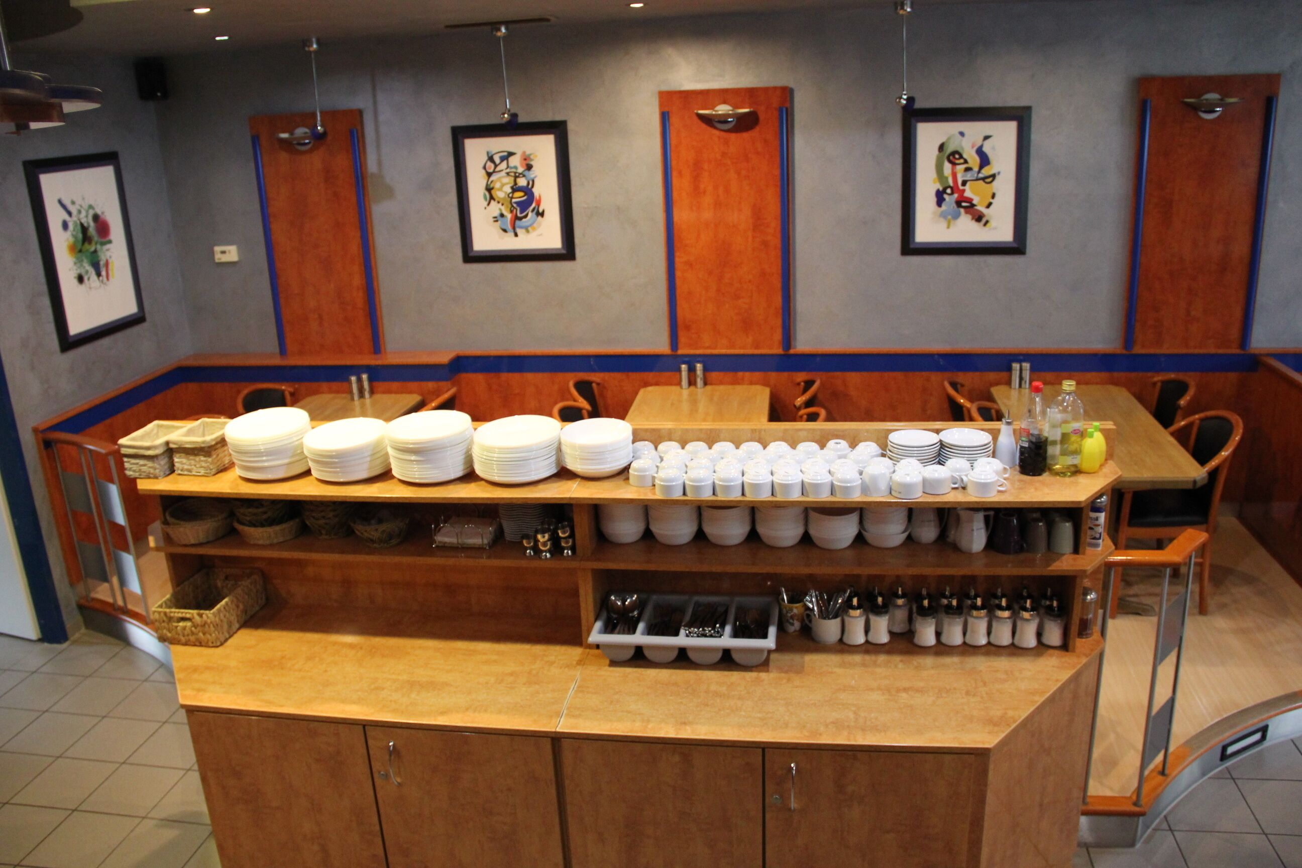 A buffet setup with various dishes and utensils.