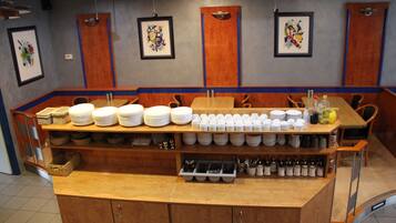 A buffet setup with various dishes and utensils.