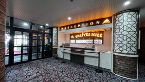 A reception area with a sign reading "Reception" and "Mercyes Hill".