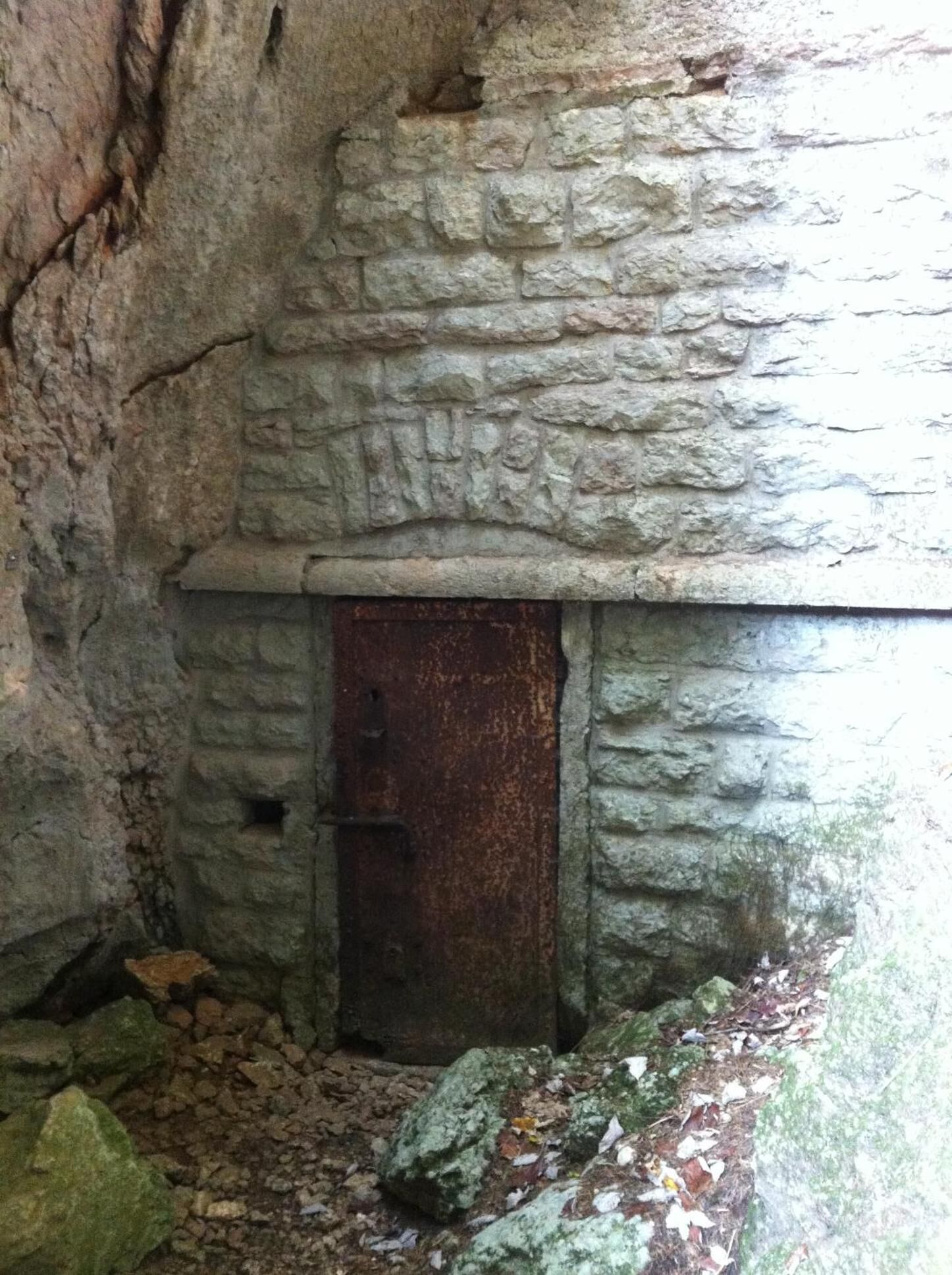 A stone wall with a rustic, weathered door.