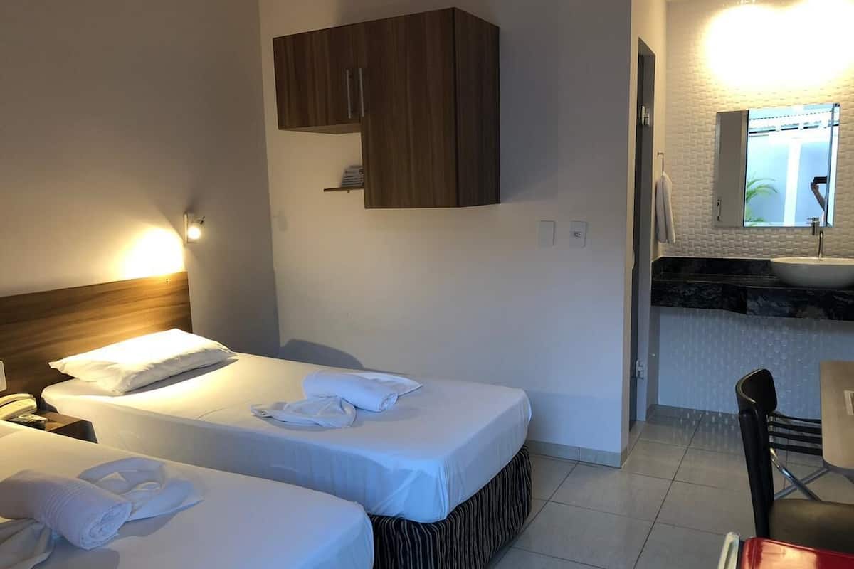 Twin Room | Desk, laptop workspace, blackout drapes, iron/ironing board