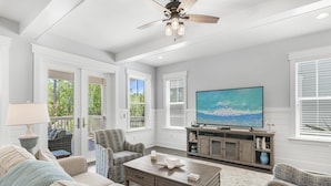 A spacious living room with a ceiling fan, a large flat-screen TV, and a comfortable seating area with sofas and chairs. - 3,000+ Sq Ft! 5 Bikes! 3 King Suites- Serenity Pond at NatureWalk on 30A (Santa Rosa Beach)