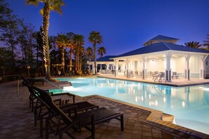 A pool area with lounge chairs and a covered seating area at dusk. - 3,000+ Sq Ft! 5 Bikes! 3 King Suites- Serenity Pond at NatureWalk on 30A (Santa Rosa Beach)