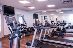 A gym with multiple treadmills, elliptical machines, and weightlifting equipment. - Holiday Inn Express & Suites Rehoboth Beach by IHG (Rehoboth Beach)