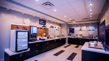 A modern breakfast area with a self-serve station, including yogurt, eggs, and milk.