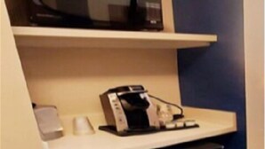 A compact kitchenette with a microwave, coffee maker, and a small refrigerator. - Holiday Inn Express & Suites Rehoboth Beach by IHG (Rehoboth Beach)