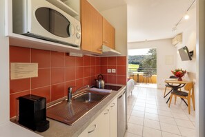 Mini-fridge, microwave, stovetop, coffee/tea maker