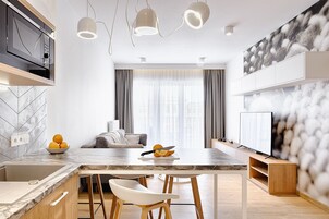 Superior Apartment, 1 Bedroom | Living room | 55-inch flat-screen TV with cable channels, TV