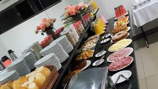 A buffet setup with various food items and utensils.