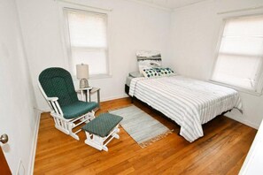 A bedroom with a single bed, a chair, a small table, and a window. - 2 blocks to ND! 4 bedroom 2 bath home(1217) (South Bend)
