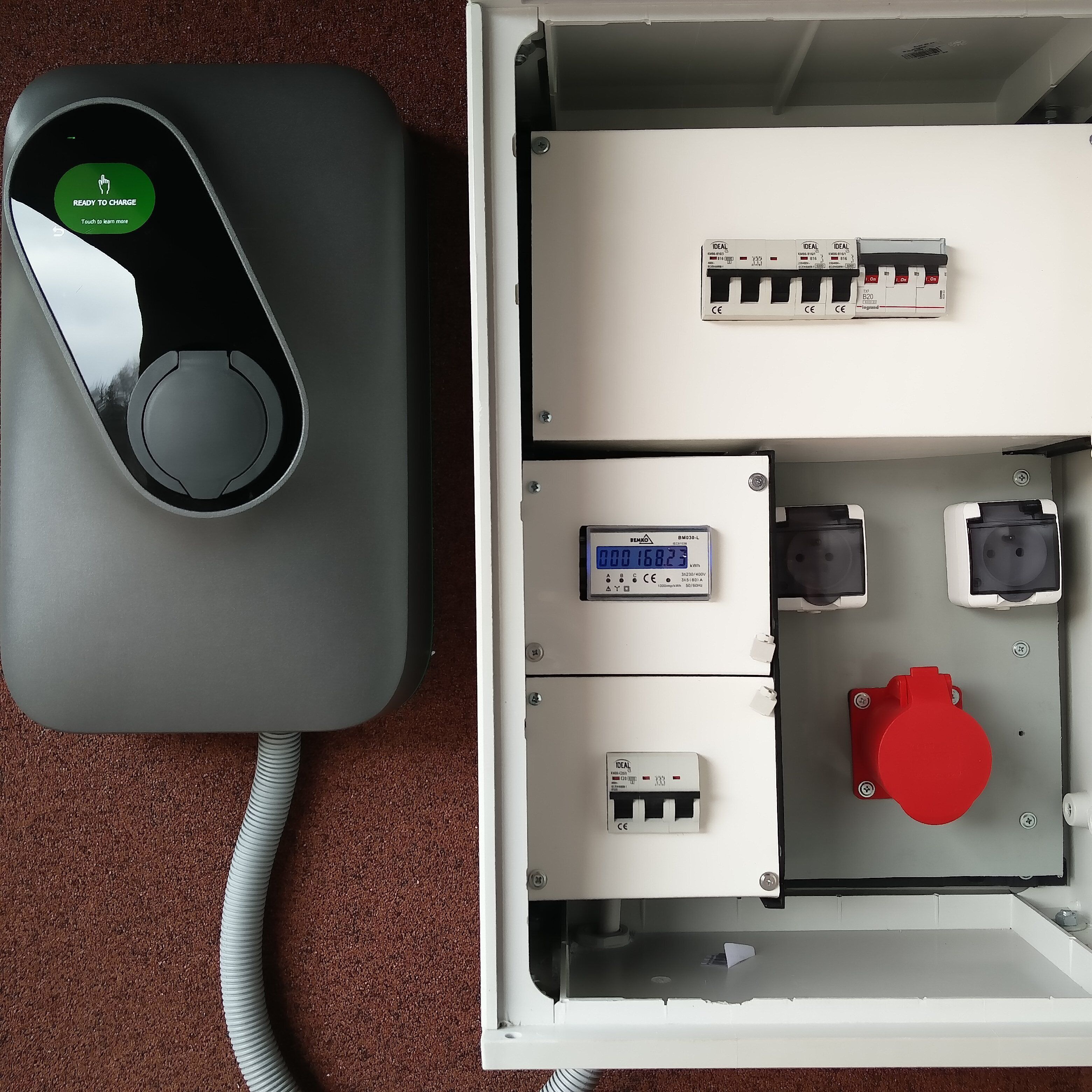 An electrical panel with a green "READY TO CHARGE" indicator, a digital display, and various switches and sockets.