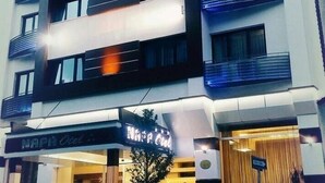A multi-story hotel with balconies, a visible entrance, and a sign that reads "Naph Hotel". - Napa Otel (Denizli)