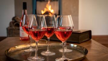 Four wine glasses filled with red wine on a tray.