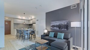 Un appartement moderne comprenant un coin repas, une cuisine et un salon.