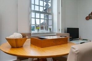 Enjoy a view of the city from the large window, with a flat-screen TV and a round table for relaxation.