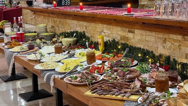 A buffet table with various food items and a clock displaying 8:39.
