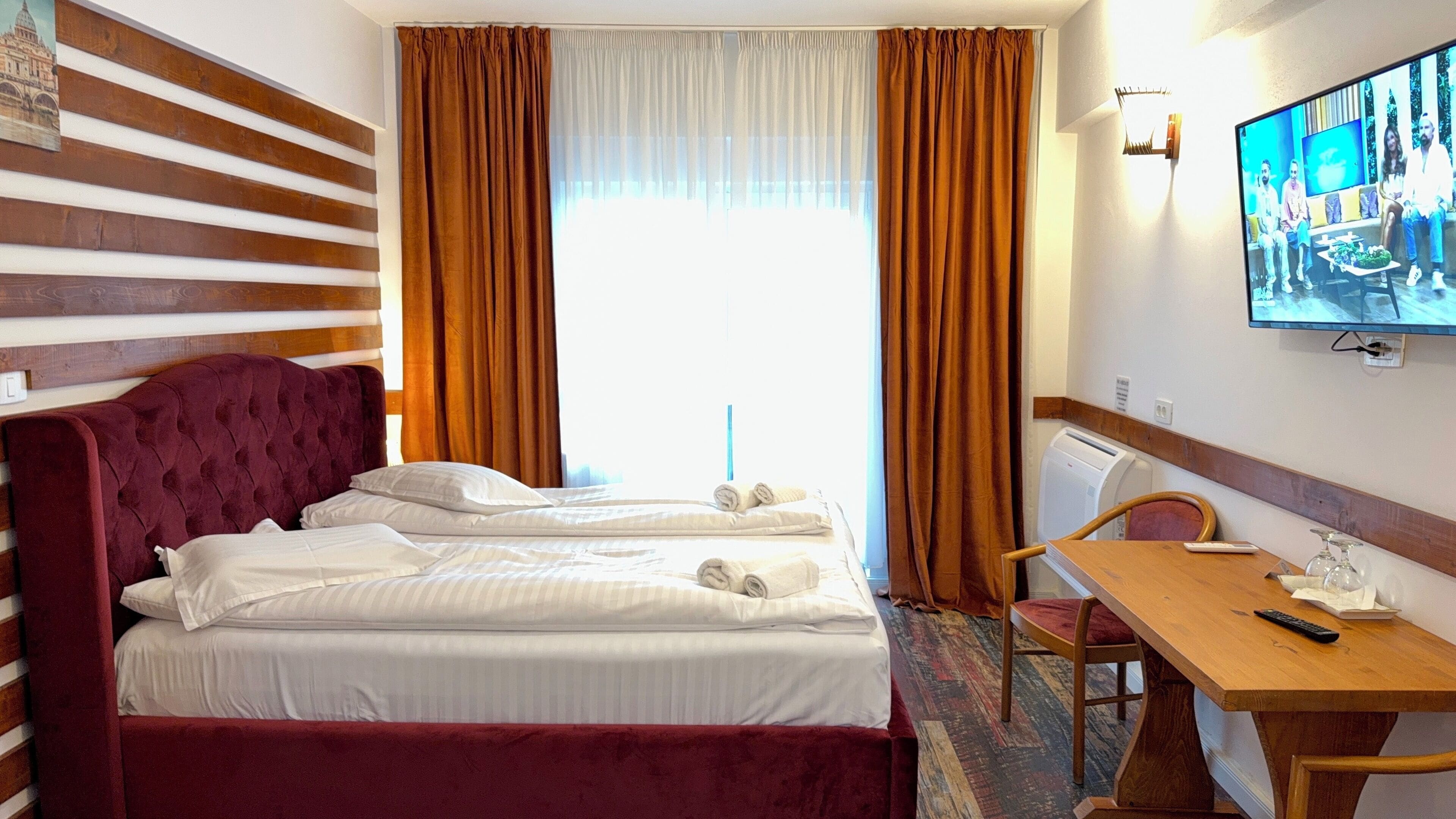 Desk, laptop workspace, iron/ironing board, bed sheets