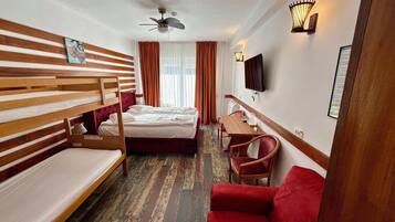 Desk, laptop workspace, iron/ironing board, bed sheets