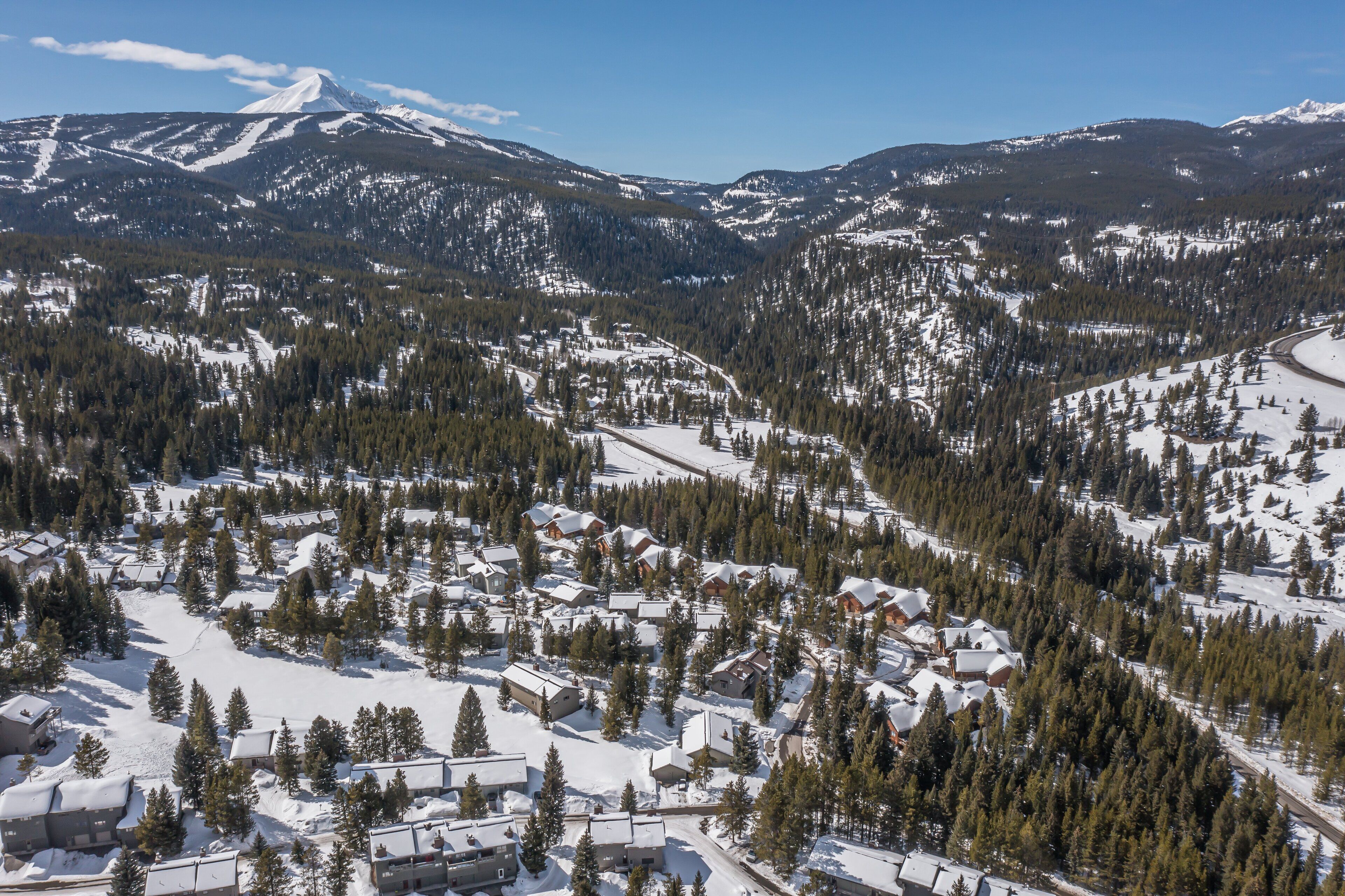 A snow-covered mountain landscape with a ski resort.