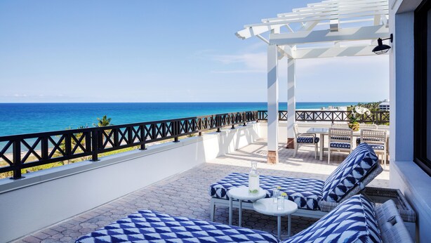 A balcony with a view of the ocean, white outdoor furniture, and a pergola. - Opal Grand Oceanfront Resort & Spa (Delray Beach)