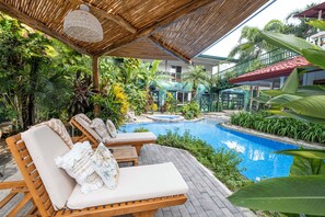 A poolside area with lounge chairs and a small pool. - 🌴16 Bed Compound Oasis 🌴Downtown Jaco with Private Pool & Hot Tub (Jaco Beach)