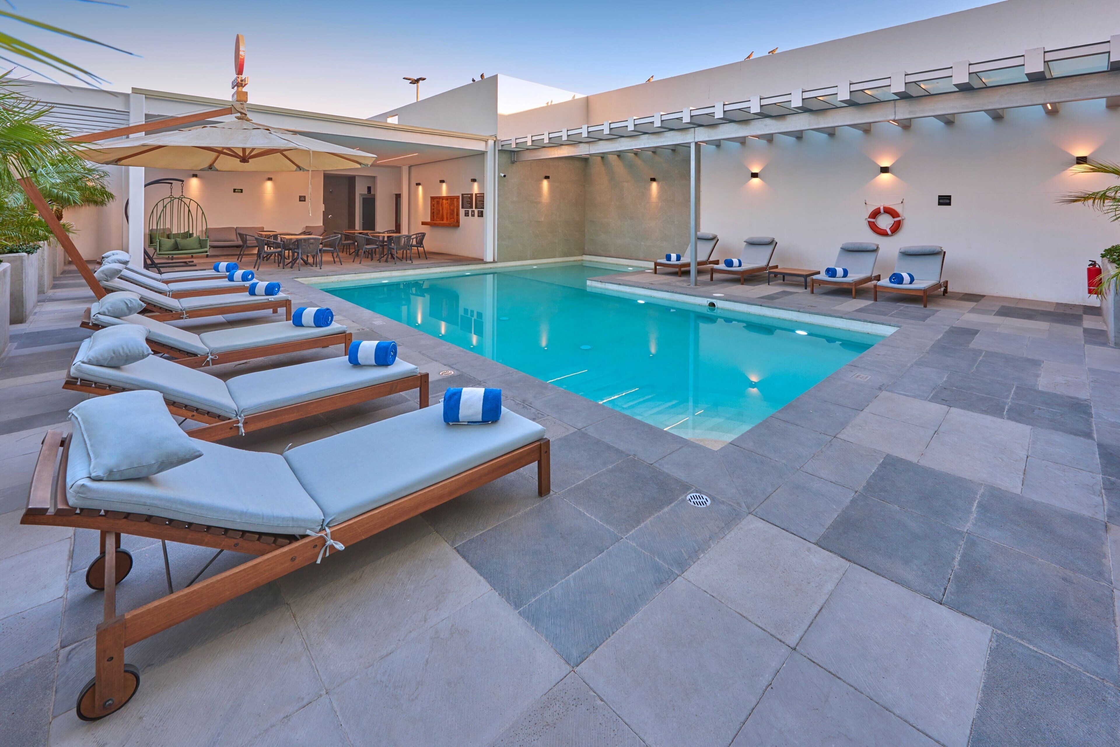 outdoor pool, open 8:00 am to 8:00 pm, pool umbrellas, pool loungers