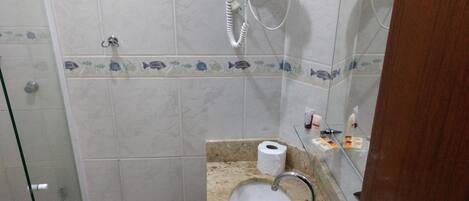 A bathroom with a shower, a sink, and a toilet.