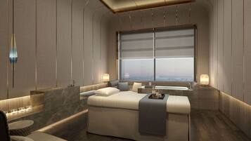 Relax in a spacious room with a large bed, seating area, and city view.