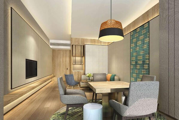 A modern dining area with a wooden table, grey upholstered chairs, and a hanging light fixture. - Wyndham Baise Resort (Baise)