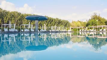 Seasonal outdoor pool, open 9:00 AM to 7:00 PM, pool umbrellas